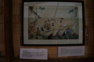 Illustrating the rice farms and homes in a village being bombed and burned.