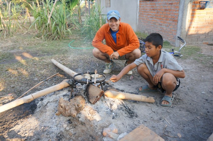 One of the kids cooking the fish for breakfast