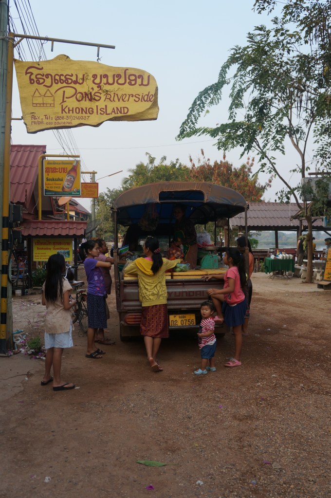 Locals buying produce for their restaurants from a grocery store on wheels! Yes, that is a songthaew.
