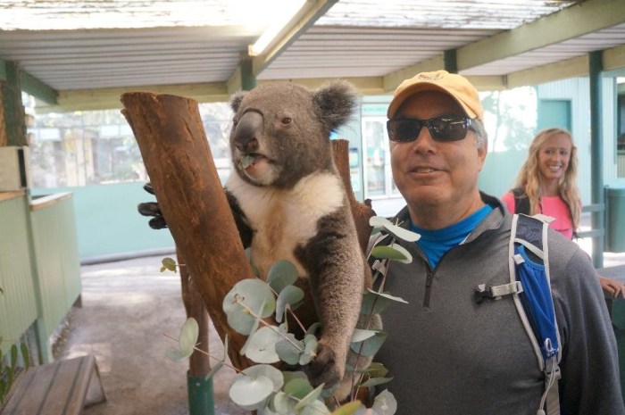 Larry posing with a rambunctious little koala. 