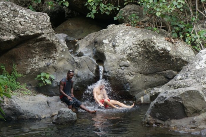 A little splish splash in a waterfall we stumbled upon. Our local guide, who did the entire hike barefoot, is next to Brian.