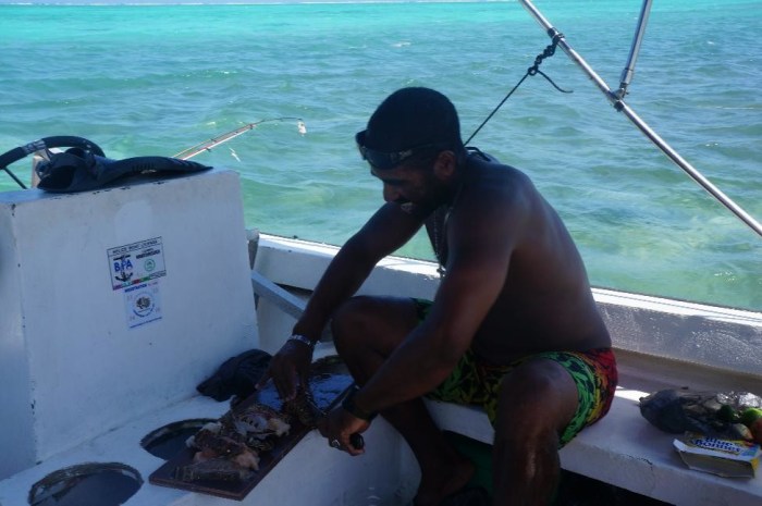 Scuba Steve preparing a freshly caught lobster lunch during our full day of snorkeling and boating