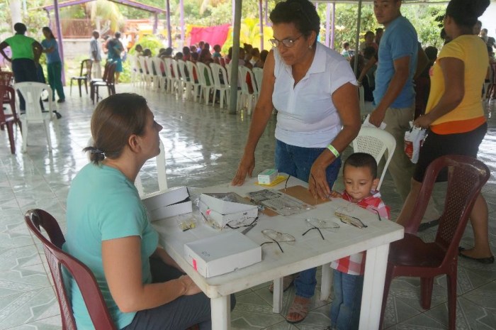 My roommate, Maria, helping a woman with new glasses