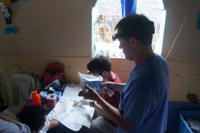 Michael and Phil separating the young man's fingers.